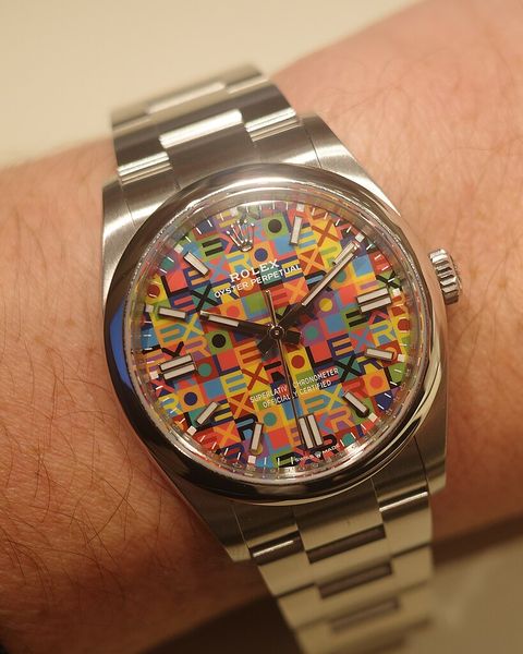 A steel Rolex Oyster Perpetual with multicoloured 'Celebration' dial on a wrist